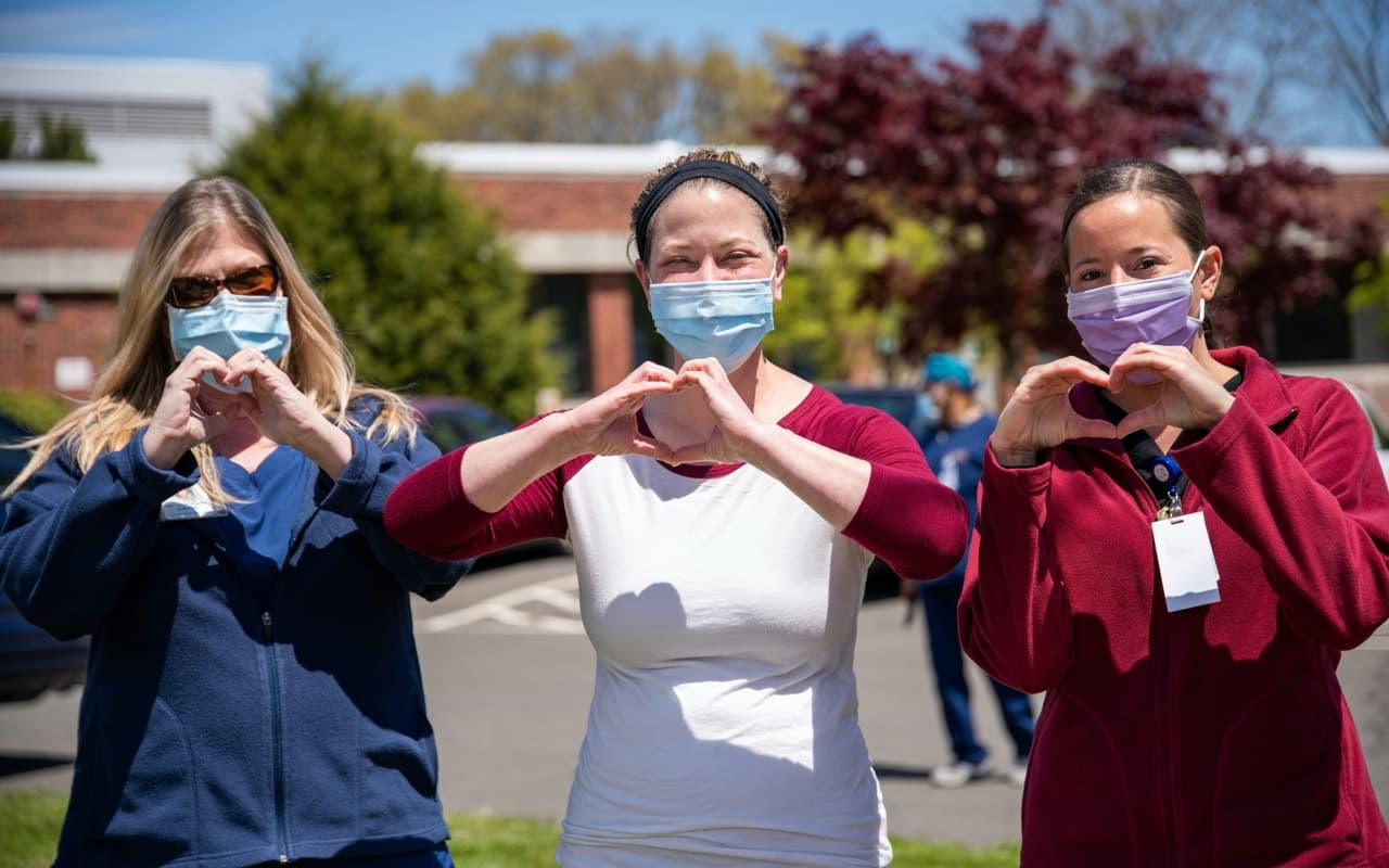 CSL team members making heart gestures
